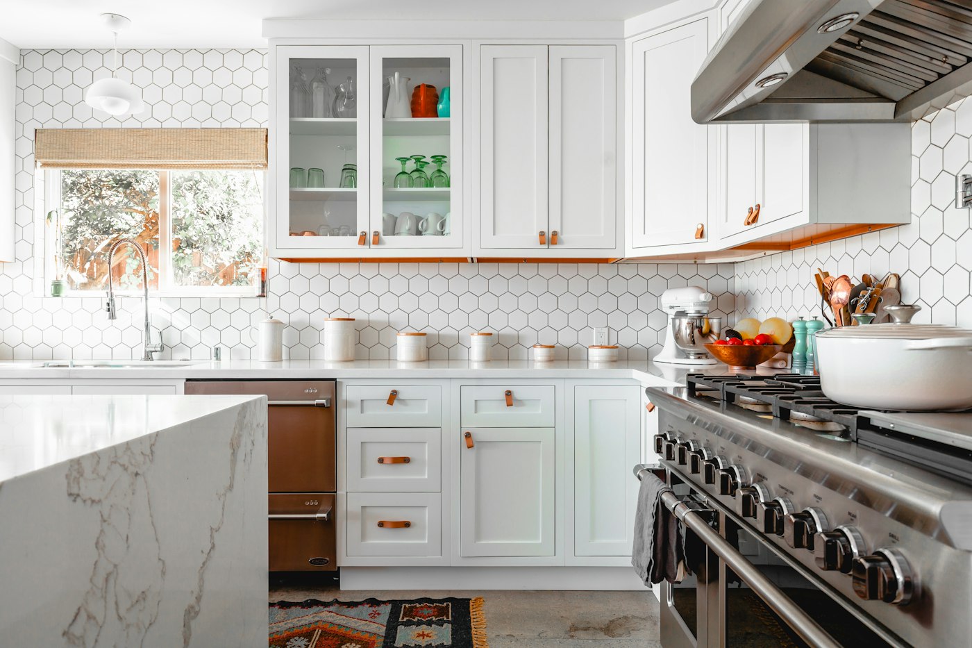 Sunlit kitchen with wood cabinets and a dining table